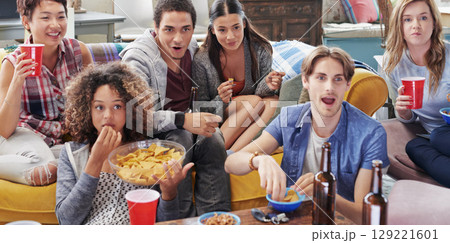 Drinks, food and group of friends watching tv in home, having fun and bonding together. Relax, chips and happy people enjoy beer on sofa while streaming video or comedy movie on television in house. 129221601