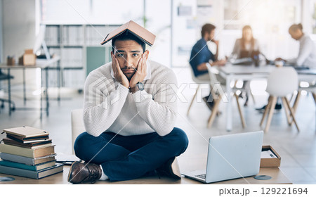 Laptop, books and businessman in training fail, burnout and stress with overwhelm workload in office, depression and tired. Corporate, business and sad man on a table, bored and moody while working 129221694