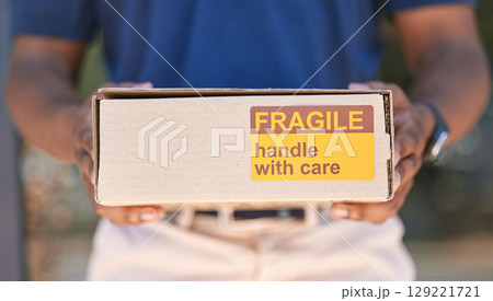 Hands, logistics and box for special delivery, cargo or handle with care sign for shipping. Hand in deliver holding fragile cardboard box packaging for online purchase, export or courier service Hands, logistics and box for special delivery, cargo or handle with care sign for shipping. Hand in deliver holding fragile cardboard box packaging for online purchase, export or courier service 129221721