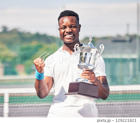 Celebration, tennis and black man with trophy on court after success, achievement and winning tournament. Fitness, champion and tennis player with award from win in sports game, event and competition Celebration, tennis and black man with trophy on court after success, achievement and winning tournament. Fitness, champion and tennis player with award from win in sports game, event and competition 129221821