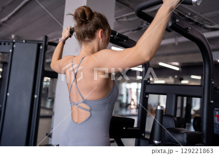 Back, pull up and woman in gym for workout, power and exercise for fitness, body health or strong core. Grip, hanging and athlete on bar for abs or leg raises for balance, training and muscle growth Back, pull up and woman in gym for workout, power and exercise for fitness, body health or strong core. Grip, hanging and athlete on bar for abs or leg raises for balance, training and muscle growth 129221863