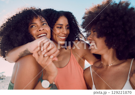 Black women, relax and friends hug at beach, having fun and bonding. Travel, freedom and group of females embrace outdoors on seashore, smiling or laughing, talking and enjoying quality time together 129221870