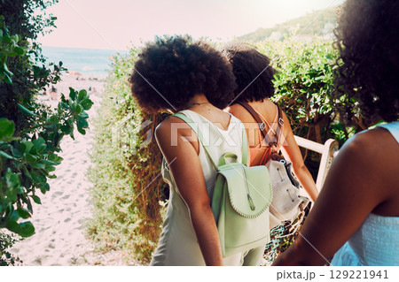 Friends walking to beach for summer travel, vacation and fun holiday together in sunshine. Back of black women, girl group and people traveling to sea sand, ocean and relax in fresh air of nature 129221941