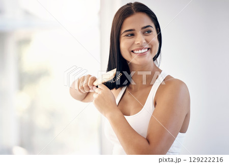 Woman, hair care and brush of a model after hair salon for beauty, wellness and healthy hairstyle. Person from Iraq with clean, natural and luxury hairdresser style smile from haircut happiness 129222216