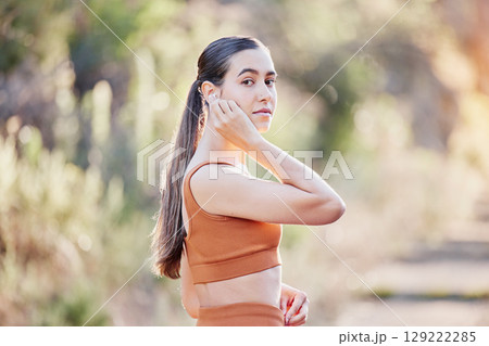 Fitness portrait, earphones and woman in nature streaming podcast, radio or motivation music for running. Sports, healthcare and female from Canada listening to audio and getting ready for training. 129222285