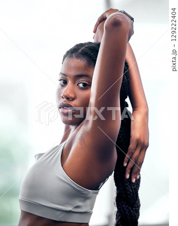 Workout, portrait and black woman stretching arm for self care, wellness and health at club. Exercise, training and athlete warm up in gym for body cardio with serious and determined face. Workout, portrait and black woman stretching arm for self care, wellness and health at club. Exercise, training and athlete warm up in gym for body cardio with serious and determined face. 129222404