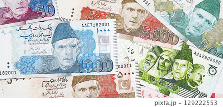 Pakistan rupees banknotes. The current Pakistan money bills lies on table in big amount Pakistan rupees banknotes. The current Pakistan money bills lies on table in big amount 129222553