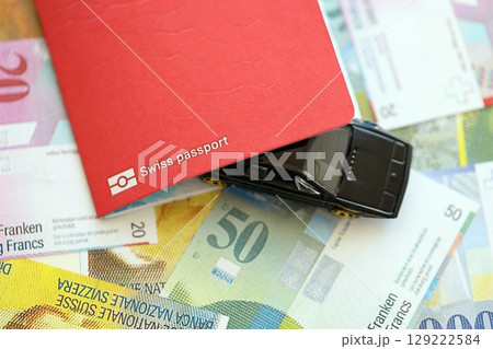 Swiss franc banknotes and toy car with passport. The current francs money bills and car with pass 129222584