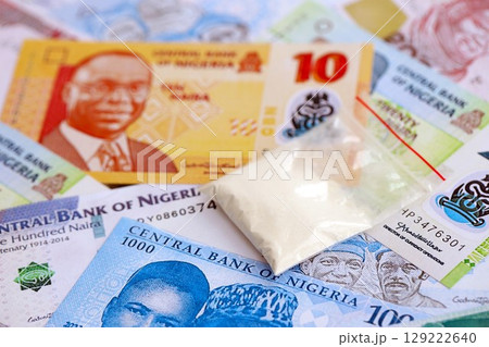 Nigerian naira currency money bills and cocaine pack. The concept of drug trafficking 129222640
