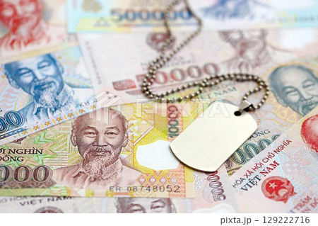 Vietnamese dong currency money bills and military token. The concept of army service 129222716