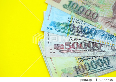 Vietnamese dong money bills in big amount on yellow. Finance and banking concept 129222730