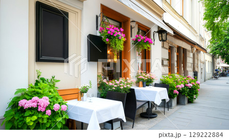 Cozy cafe with vibrant flowers and elegant outdoor seating 129222884