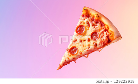 Single slice of pepperoni pizza with melted cheese dripping against vibrant, colorful backdrop 129222919