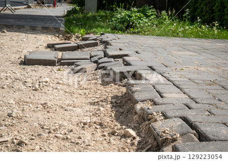 Unfinished Pavement with Exposed Sand and Displaced Bricks at Construction Site 129223054