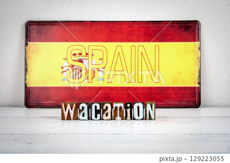 Spain Vacation Concept with Wooden Letter Blocks and Flag Background 129223055