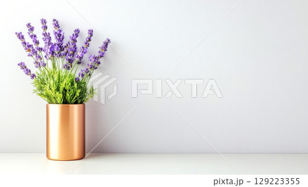 Lavender flowers arranged in a sleek copper vase against a minimalist background Lavender flowers arranged in a sleek copper vase against a minimalist background 129223355