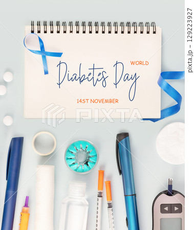 Diabetes Day. Glucose meter, test strips for determining blood sugar levels, syringes for insulin injections, sanitizing on a blue background with notebook with inscription World Diabetes Day 129223927