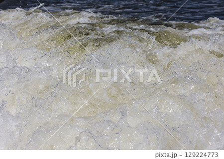 Turbulent water, showing churning foam, bubbles, and surface tension. Turbulent water, showing churning foam, bubbles, and surface tension. 129224773