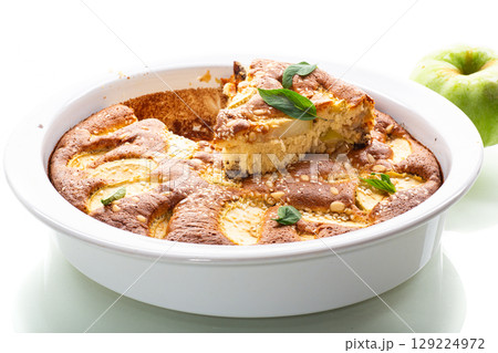 Ruddy crust of an appetizing apple pie on a white background 129224972