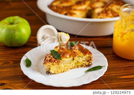 Golden charlotte with juicy filling and sesame seeds on top Golden charlotte with juicy filling and sesame seeds on top 129224973