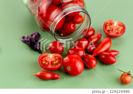 Appetizing marinated tomatoes for the winter menu in clean jars Appetizing marinated tomatoes for the winter menu in clean jars 129224990