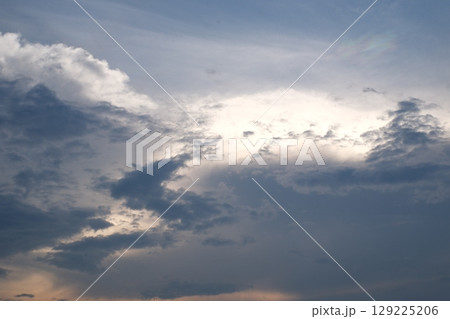 Sunset on blue sky. Blue sky with some clouds. blue sky clouds, summer skies, cloudy blue sky 129225206