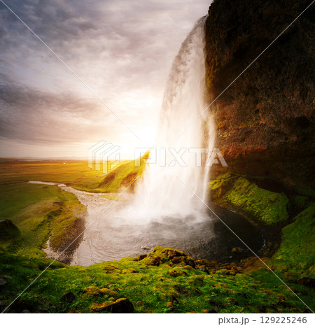 Perfect view of famous powerful Seljalandsfoss waterfall in sunlight. Location place Iceland, sightseeing Europe. 129225246