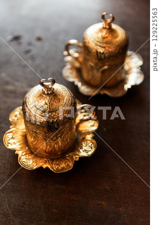 Ornate Gold-Plated Decorative Cups with Intricate Patterns Ornate Gold-Plated Decorative Cups with Intricate Patterns 129225563