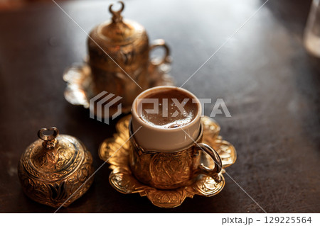 Elegant Traditional Coffee Set Featuring Ornate Design with Rich Aroma Displayed Elegant Traditional Coffee Set Featuring Ornate Design with Rich Aroma Displayed 129225564