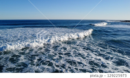 Morning Footsteps Along Serene Sandy Shoreline Morning Footsteps Along Serene Sandy Shoreline 129225973
