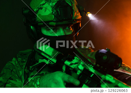 Tactical Soldier in Action Helmet On Off Dramatic Lights Smoke 129226063