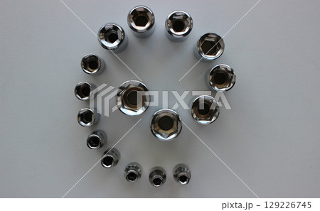 Steel Shiny Socket Wrench Nozzles In A Spiral Shape Lined By Increasing Diameter Isolated On White  129226745