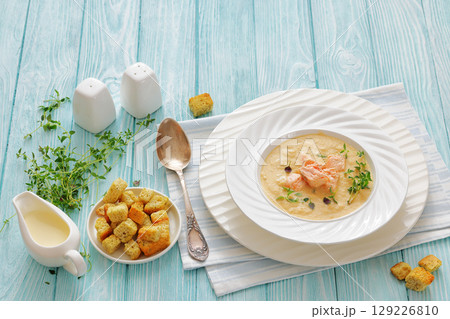 creamy salmon soup with herb in a bowl 129226810