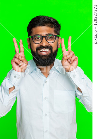 Indian man showing V sign with fingers smiling expressing victory peace positive gesture chroma key 129227271