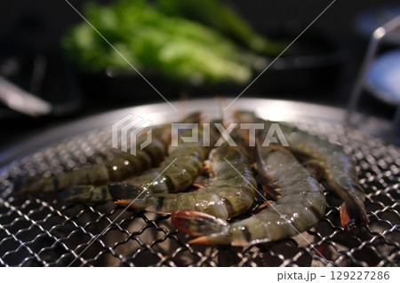 grilled shrimp with local white wine in a tavern on Santorini island in Greece 129227286