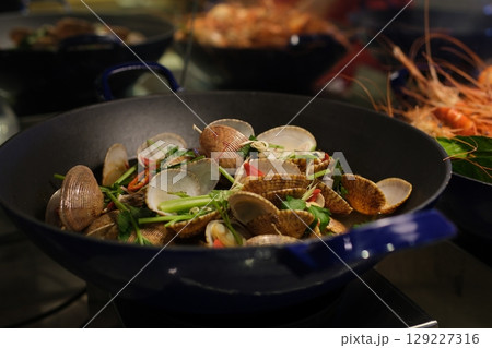 Vegetable paella with seafood on a wooden background 129227316