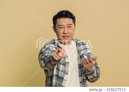 Smiling happy man pointing forward to camera, choosing lucky victory winner, indicating, promotion Smiling happy man pointing forward to camera, choosing lucky victory winner, indicating, promotion 129227511