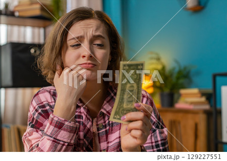Woman counting cash insufficient amount of money financial crisis bankruptcy poverty destitution Woman counting cash insufficient amount of money financial crisis bankruptcy poverty destitution 129227551