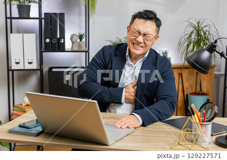 Office business man suffers from tension holding chest with heart pain attack risk of stroke symptom Office business man suffers from tension holding chest with heart pain attack risk of stroke symptom 129227571