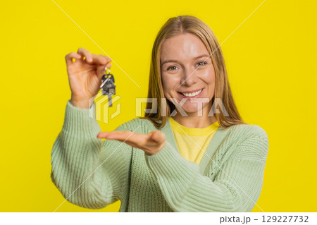 Caucasian woman real estate agent showing keys of new home house apartment, buying renting property 129227732