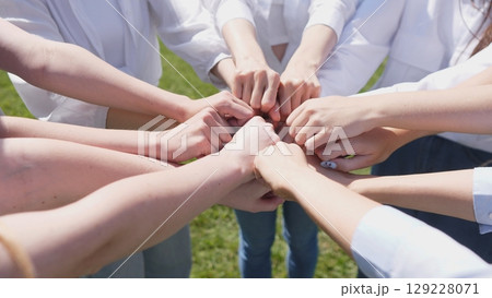A group of diverse hands coming together, symbolizing teamwork and unity in a collaborative environment. A group of diverse hands coming together, symbolizing teamwork and unity in a collaborative environment. 129228071