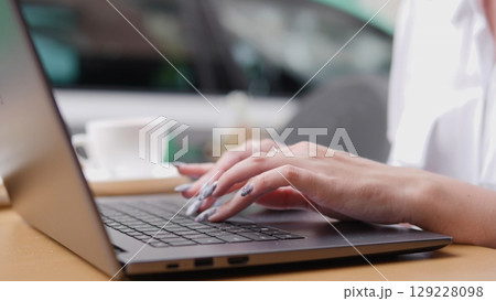 A person working on a laptop in a caf, showcasing productivity and modern worklife balance A person working on a laptop in a caf, showcasing productivity and modern worklife balance 129228098