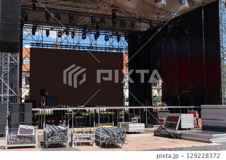 Workers installing sound and stage equipment 129228372