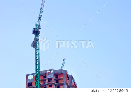Construction industry.New building.Large high rise crane Construction industry.New building.Large high rise crane 129228946