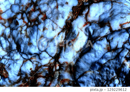 Blurred white blue marble stone surface with red veins cracks 129229612