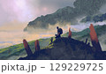 Traveler Resting on a Mountain Peak 129229725