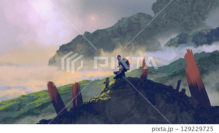 Traveler Resting on a Mountain Peak Traveler Resting on a Mountain Peak 129229725