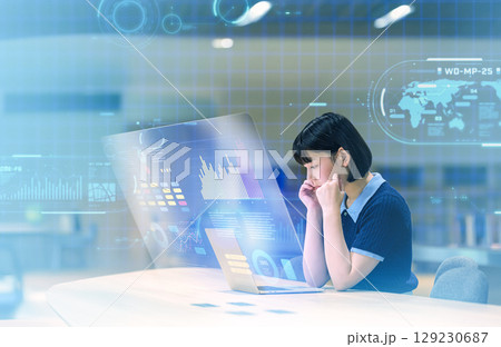 未来世界:考え事をしながらノートパソコンを見る女子大学生 未来世界:考え事をしながらノートパソコンを見る女子大学生 129230687