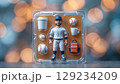Close-up of a figurine of a baseball player with removable accessories on an isolated background 129234209
