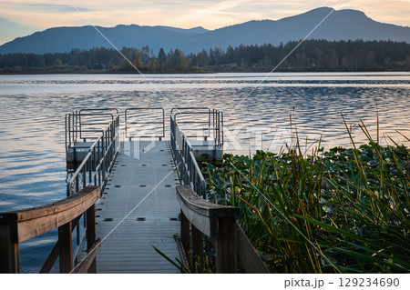 A floating dock at Quamichan Lake Provincial Park in British Columbia. Floating Jigsaw or plastic pontoon walkway floating on a lake. Floating Dock. Plastic Pontoon bridge. Beautiful landscape Canada 129234690
